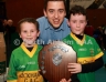 Aaron McHenry from Central Restaurant Ballycastle presenting Kickhams Creggan joint team captains Ronan Colgan and Domhall McKay with the Central Restaurant U8 Indoor Hurling Division 1 Shield
